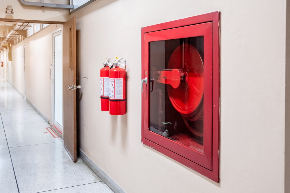 Fire extinguisher system on the wall background, powerful emergency equipment for industrial
